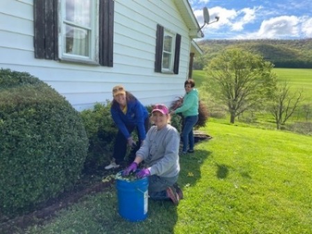 United Way team weeding lawn