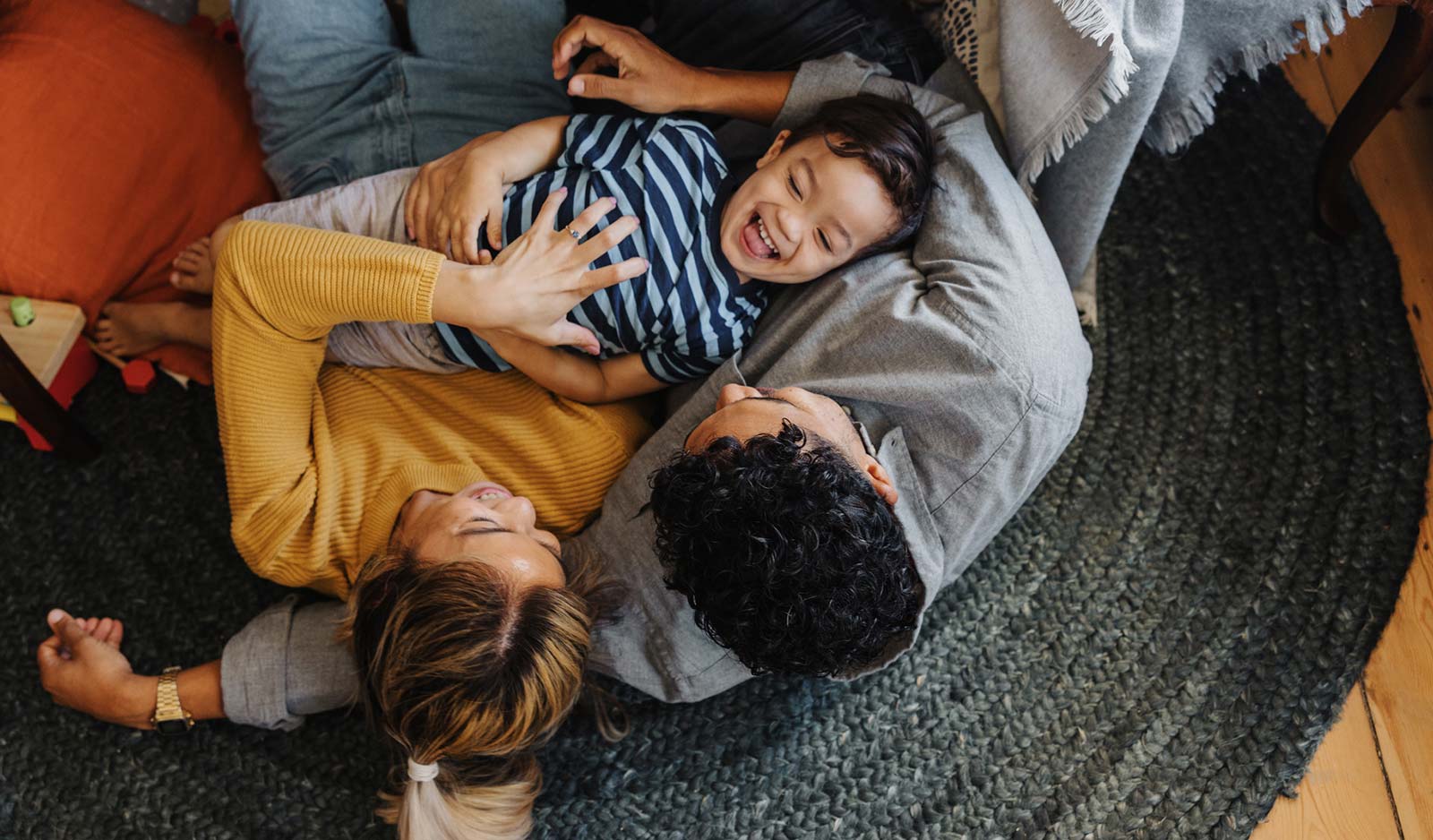 Young family playing on couch