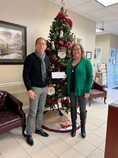 Karen giving check to food bank